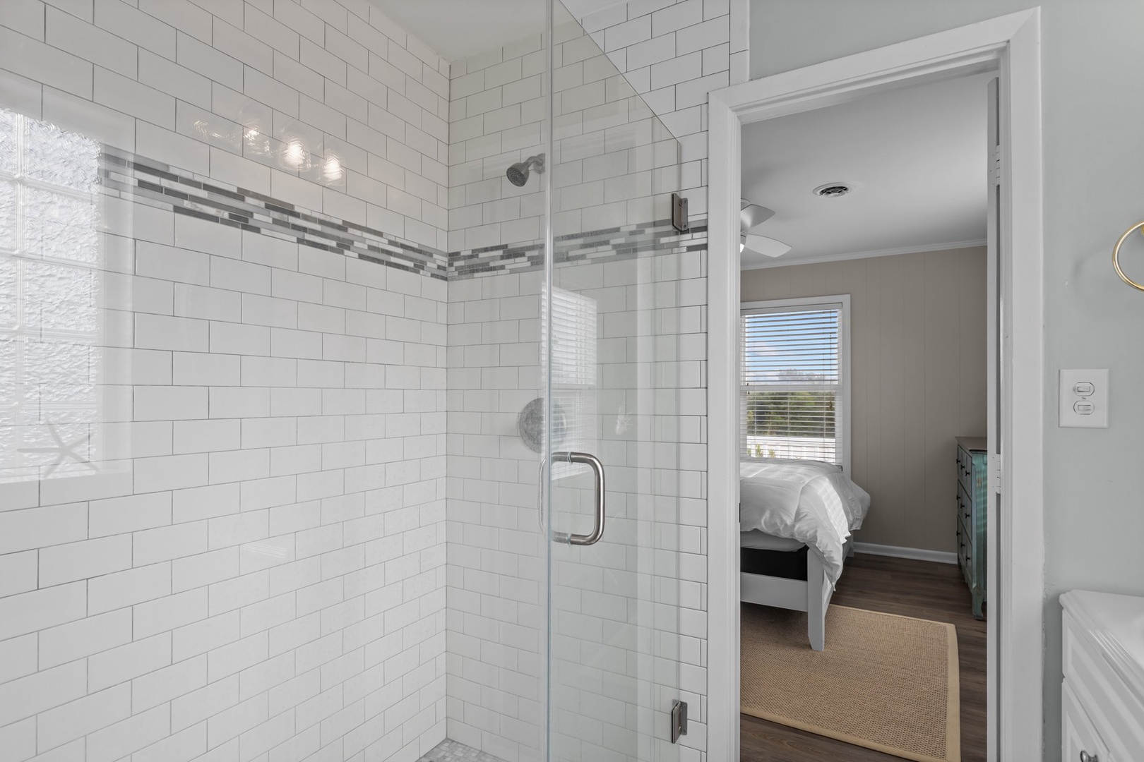 Your spacious glass shower awaits with elegant subway tile and rainfall head for the perfect morning refresh.