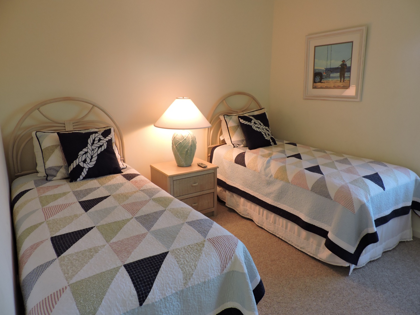 Settle into your cozy twin bedroom with soft geometric quilts and nautical touches that create the perfect restful retreat.