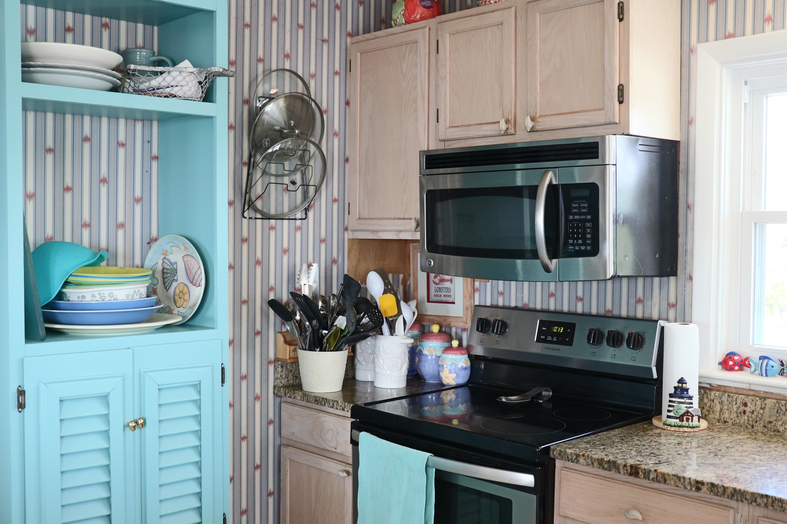 Your fully equipped kitchen awaits with modern appliances, cheerful coastal colors, and everything you need to create memorable meals during your stay.