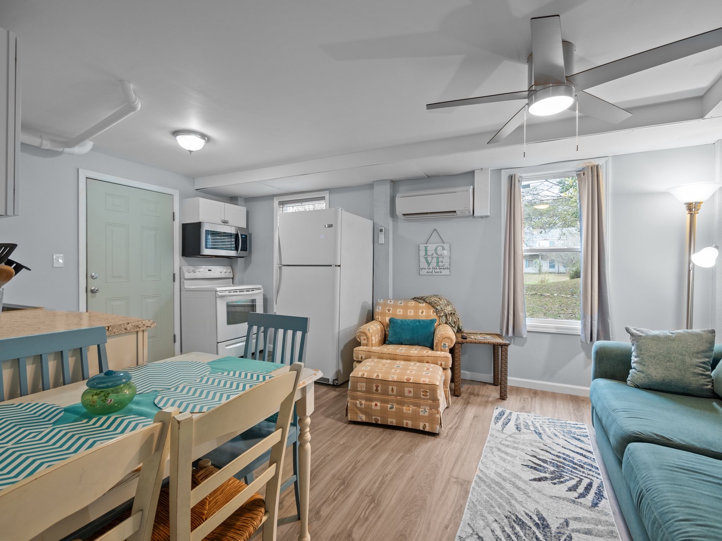 Relax in your bright, coastal-themed living space with modern amenities and charming turquoise accents throughout.
