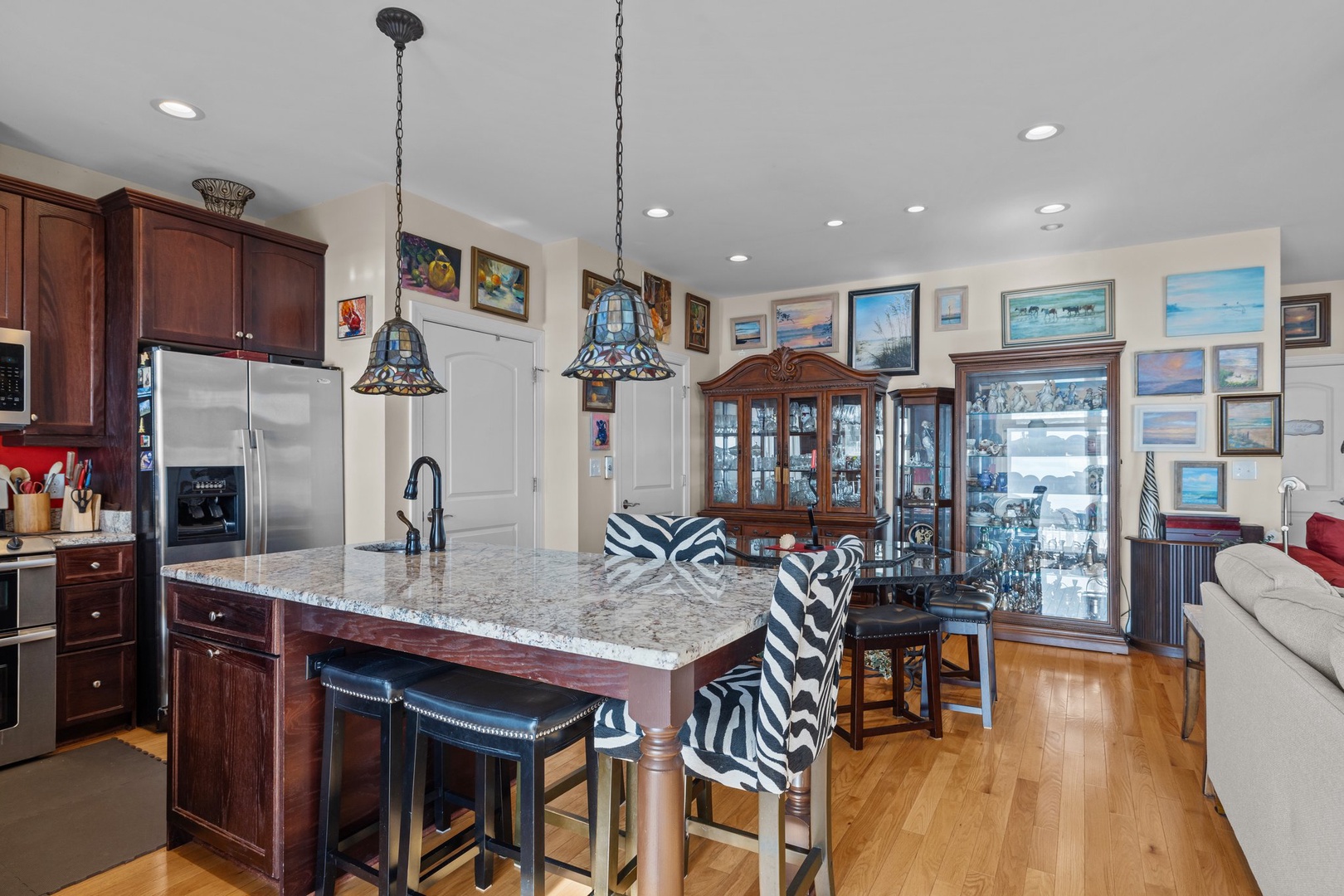 Your gourmet kitchen features rich cherry cabinets, granite counters, and stylish zebra-print seating for memorable meal prep moments.