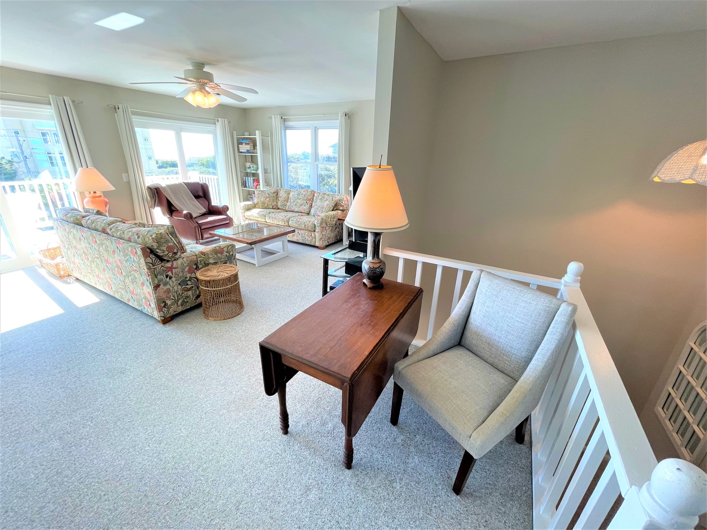 Relax in your spacious living room with comfortable seating, warm lighting, and a bright balcony perfect for morning coffee or evening unwind.