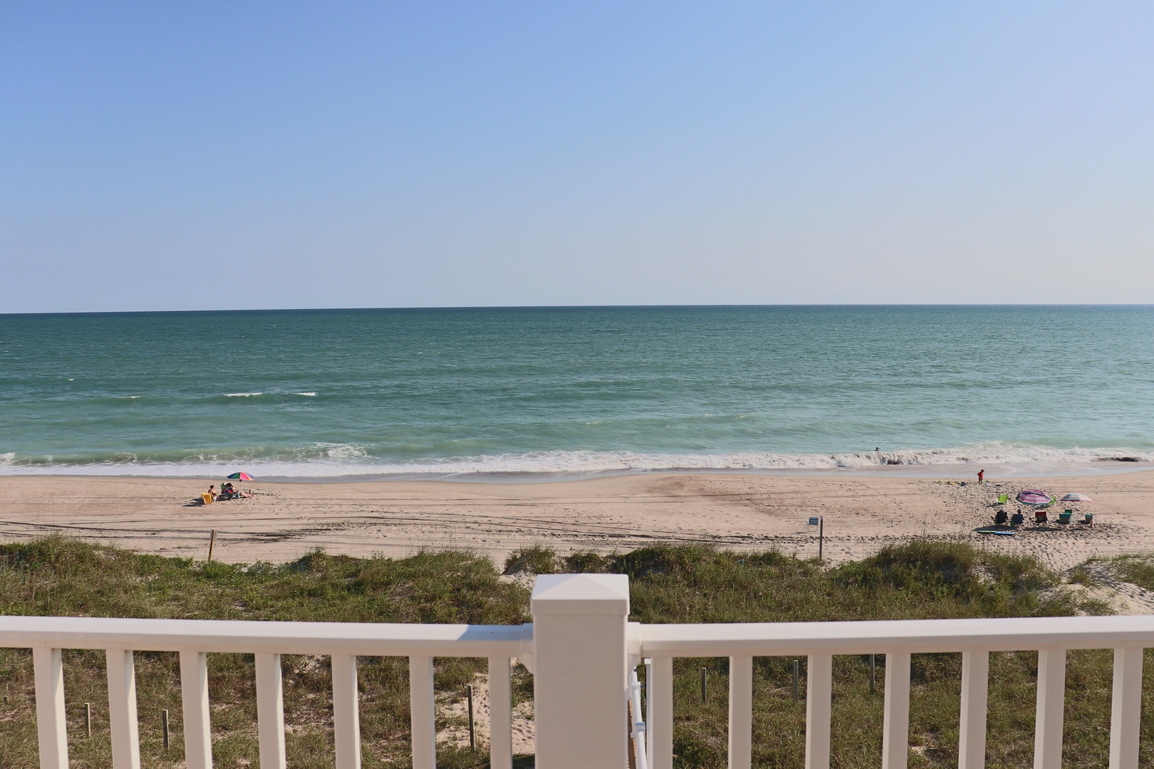 Stunning beachfront location with pristine sandy shores and gentle waves just steps from the property.