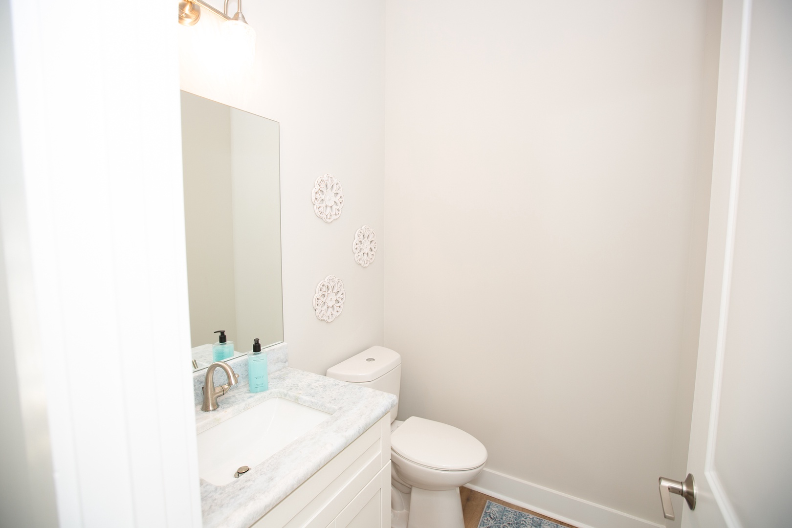 Step into your pristine powder room with elegant marble vanity and thoughtful touches that make every moment feel luxurious.