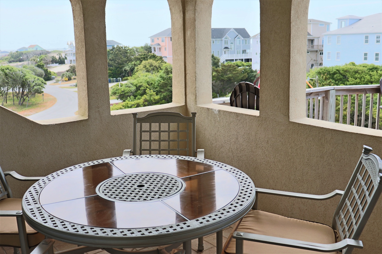 Savor morning coffee at your private balcony table while taking in peaceful neighborhood views and ocean glimpses beyond.