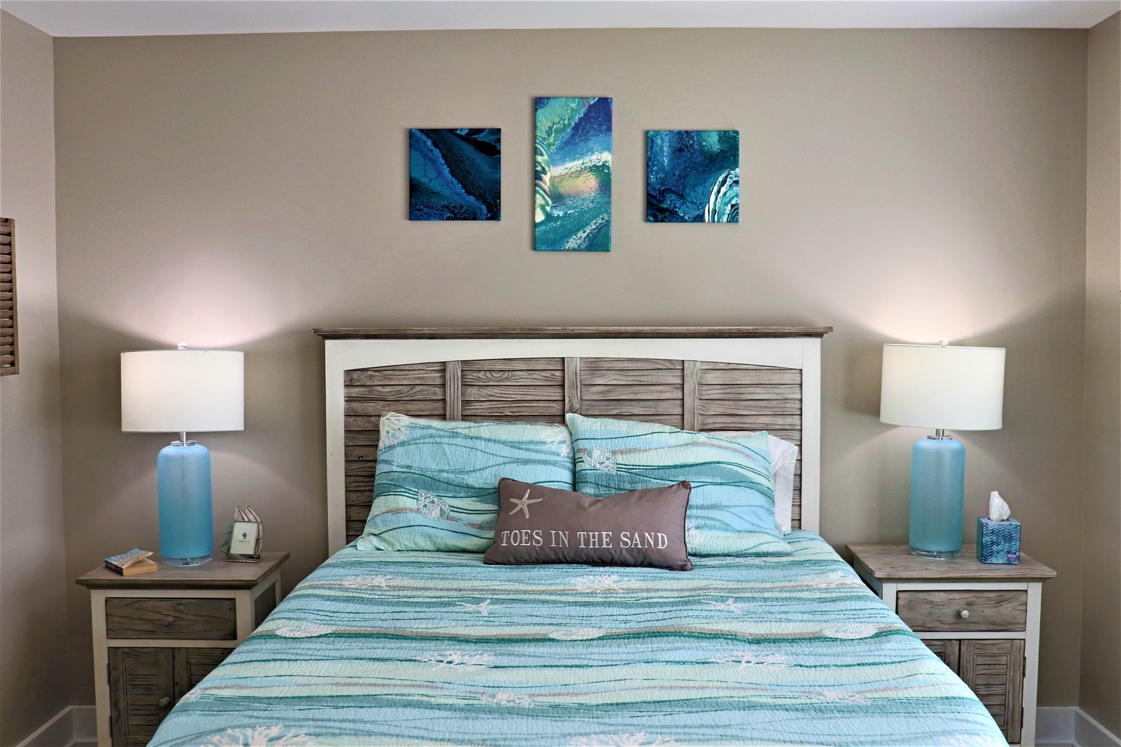 Drift off to sleep in your coastal-themed bedroom, where ocean-inspired artwork and soft turquoise bedding create a serene seaside sanctuary.