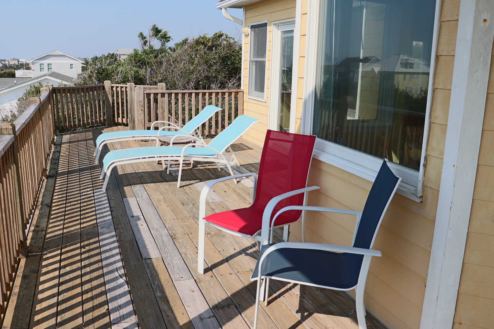 Soak up the sunshine on your private deck with colorful loungers and chairs, perfect for morning coffee or afternoon relaxation.