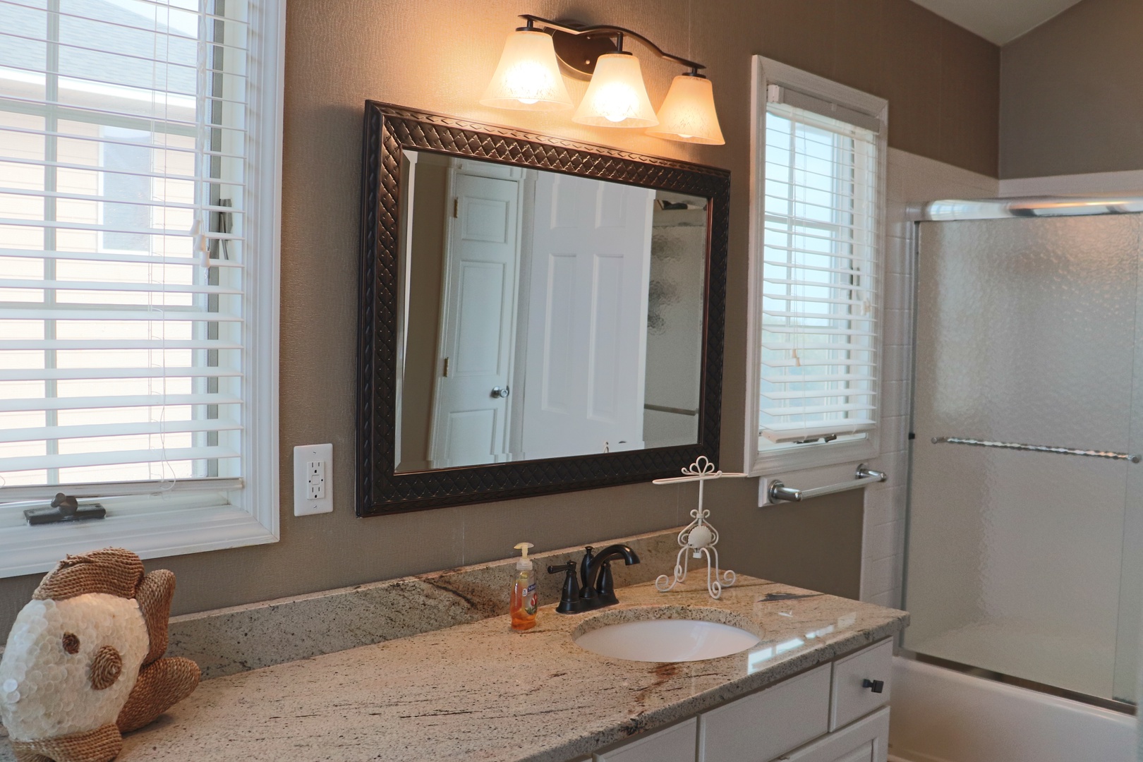 Your private bathroom features granite countertops, warm lighting, and thoughtful touches for a spa-like experience.