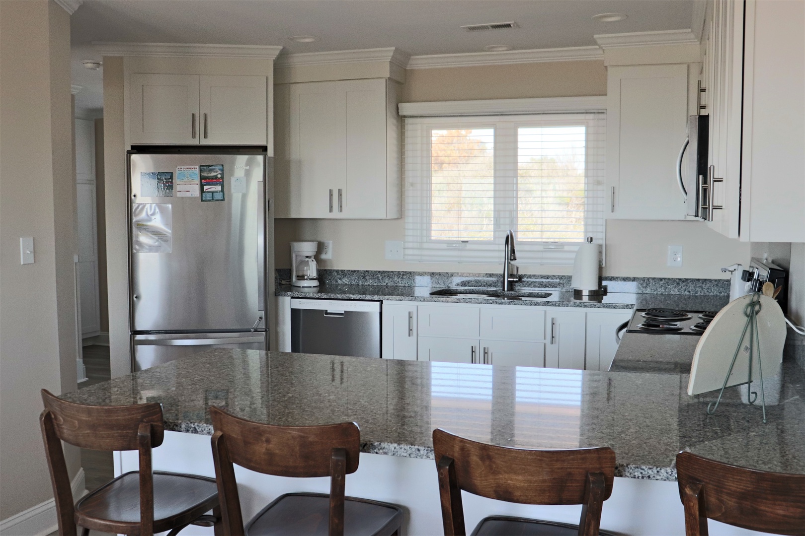 Your modern kitchen awaits with granite countertops, stainless appliances, and natural light perfect for preparing memorable meals.