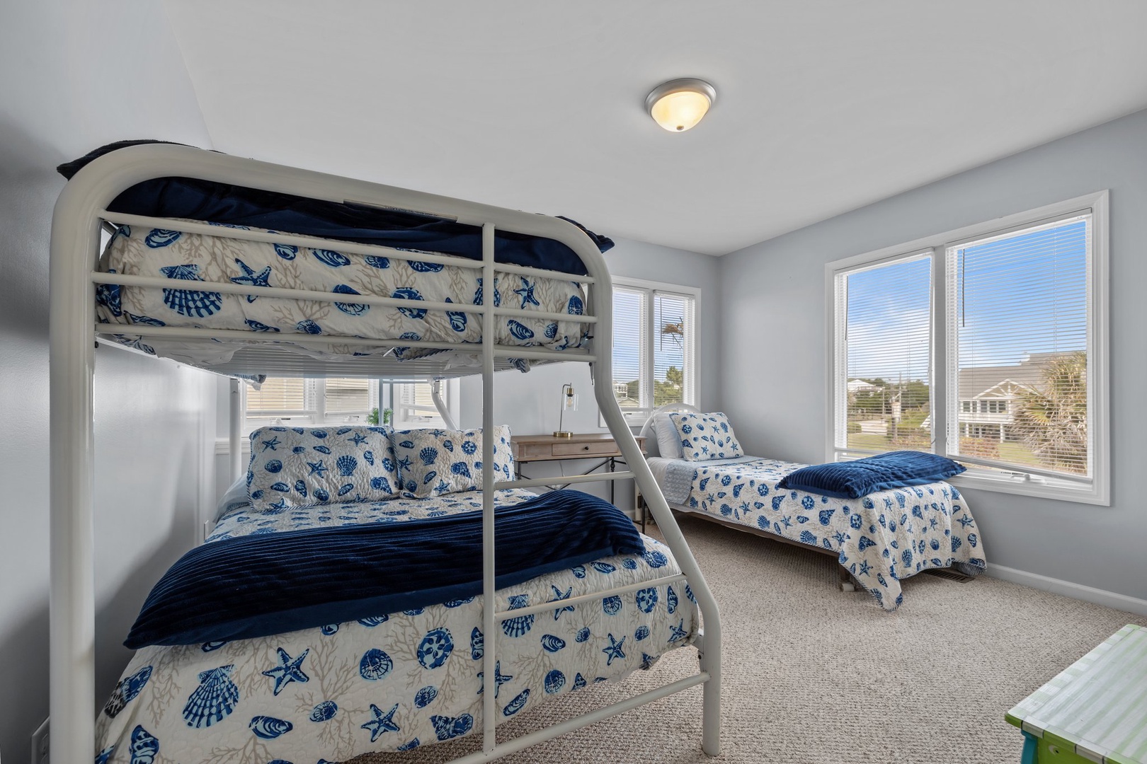 Your kids will love this coastal-themed room with cozy bunk beds and nautical bedding, perfect for bedtime stories and morning adventures.