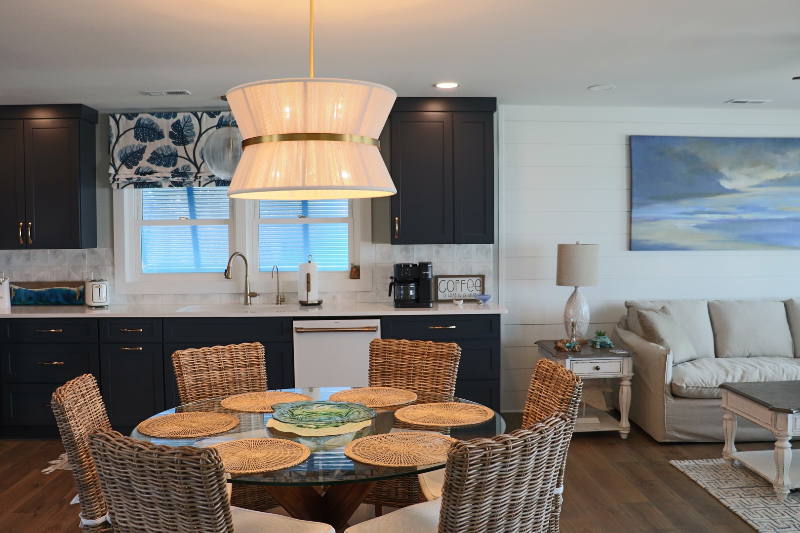 Step into your open-concept haven where coastal elegance meets modern comfort. The stunning kitchen flows seamlessly into your dining and living spaces.
