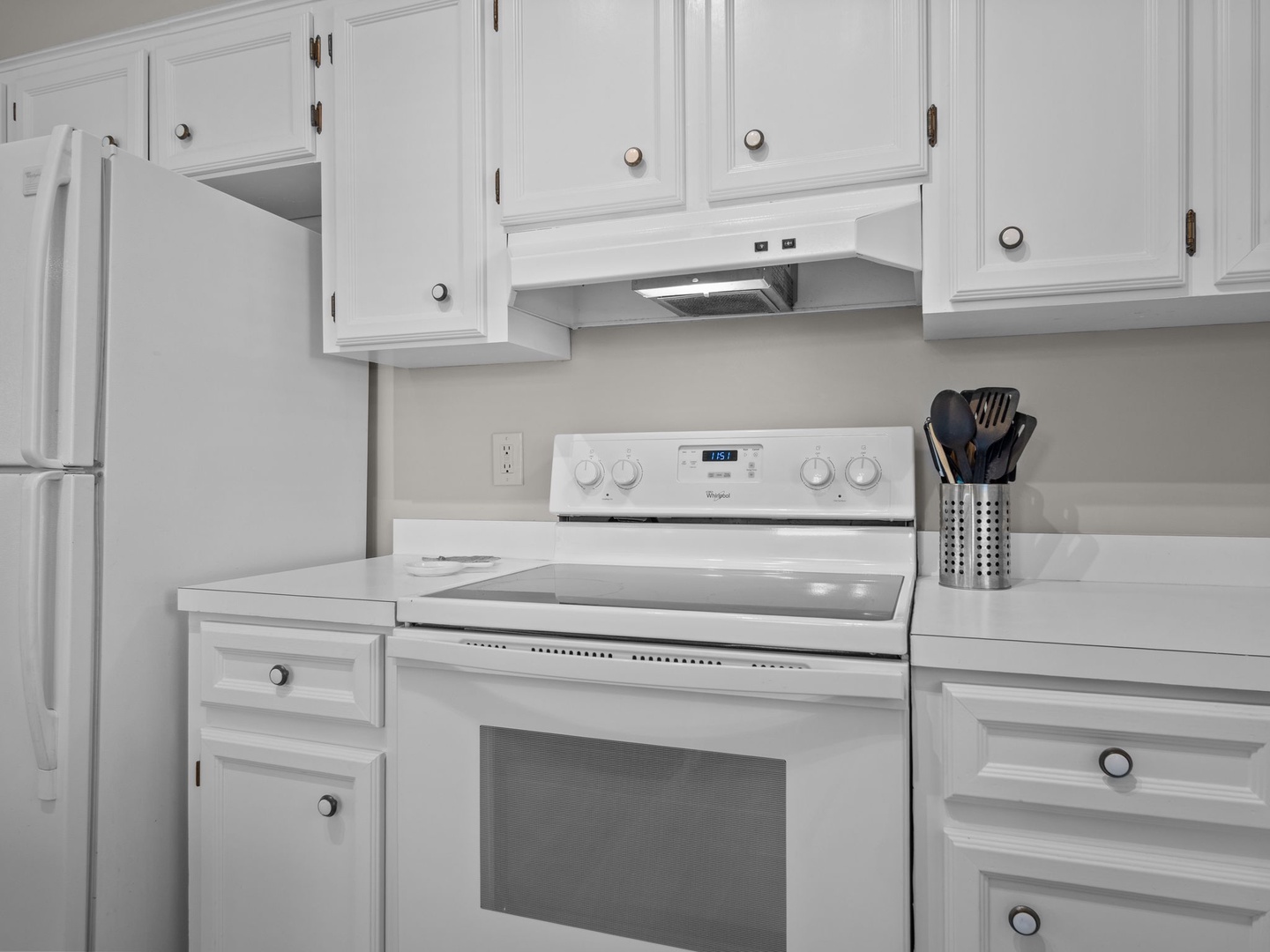 Your fully equipped kitchen awaits with white appliances and ample cabinet space for all your culinary needs.