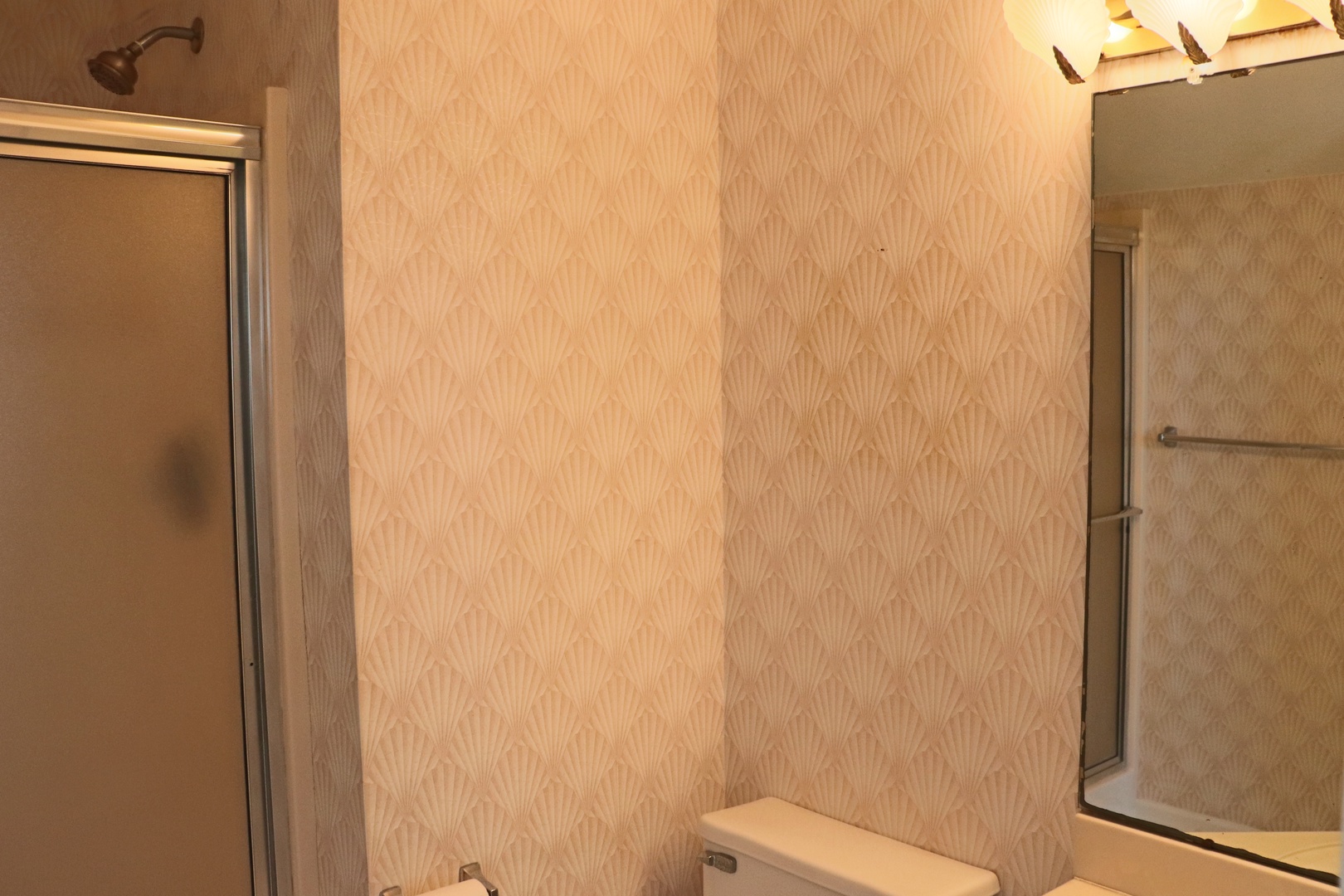Step into your private bathroom sanctuary with elegant wallpaper and modern fixtures for ultimate comfort.