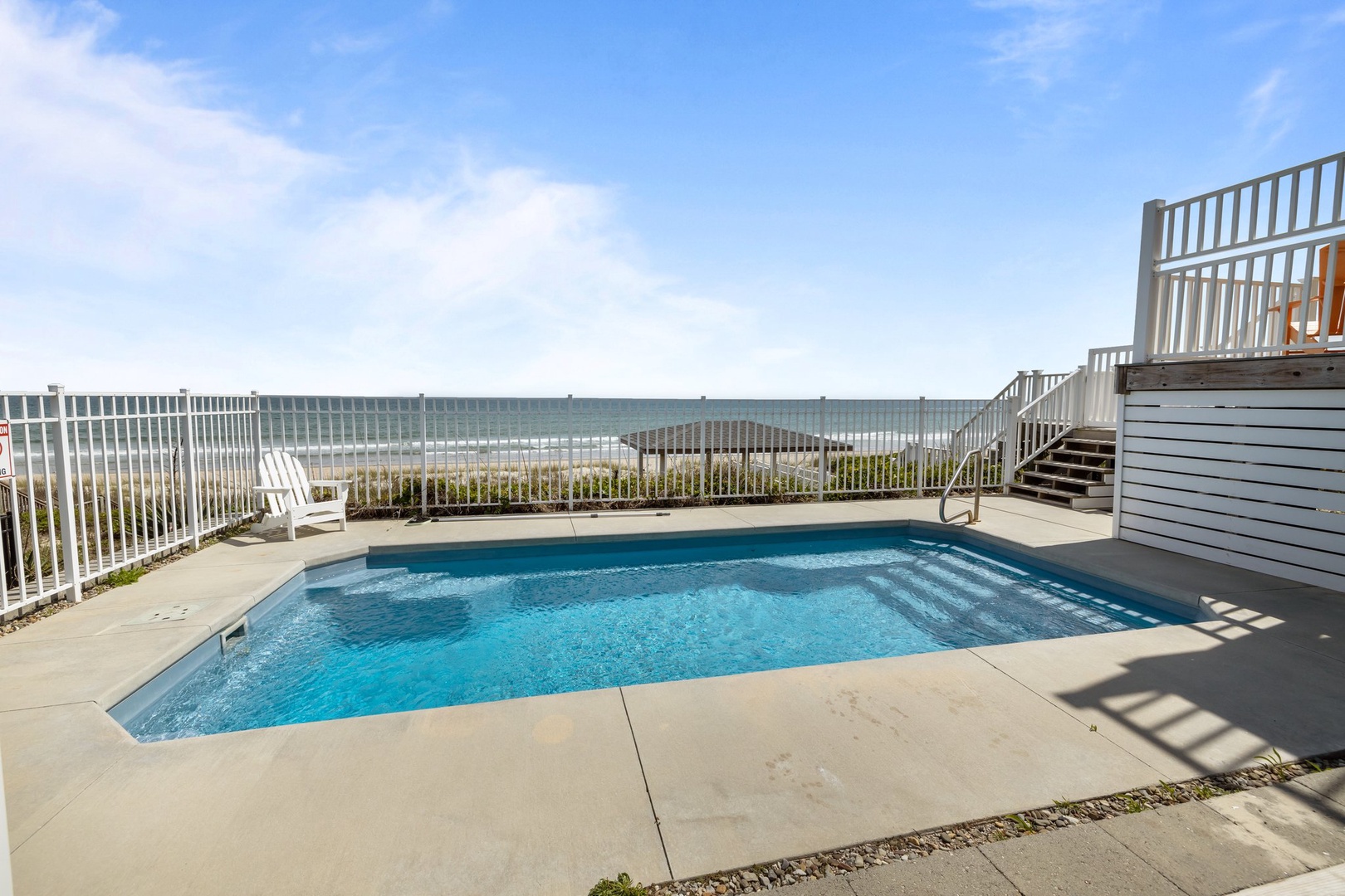 Dive into your private pool with stunning ocean views just steps from the beach in this coastal paradise.