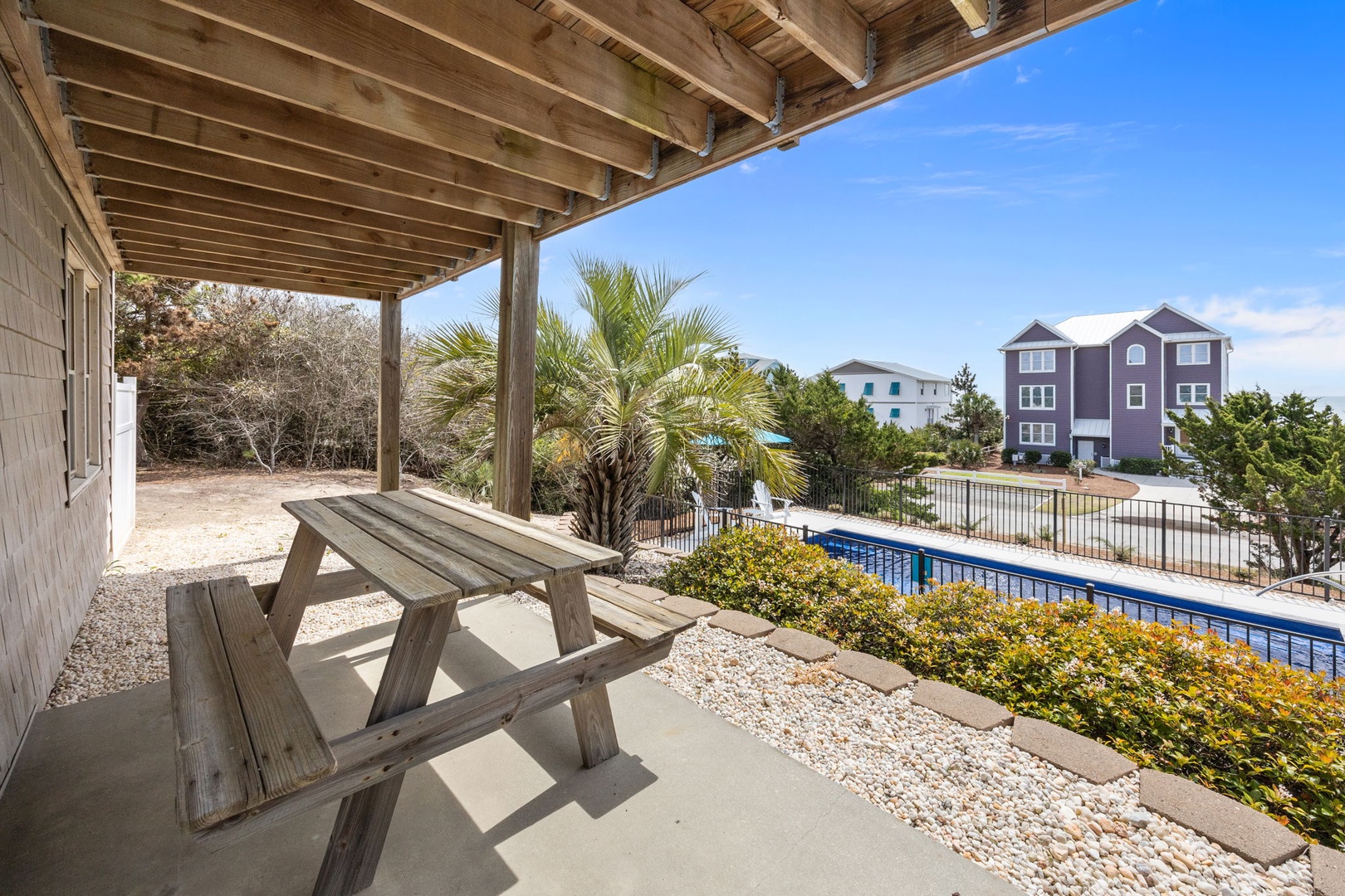 Relax on your private covered patio with tropical views and pool access just steps away.