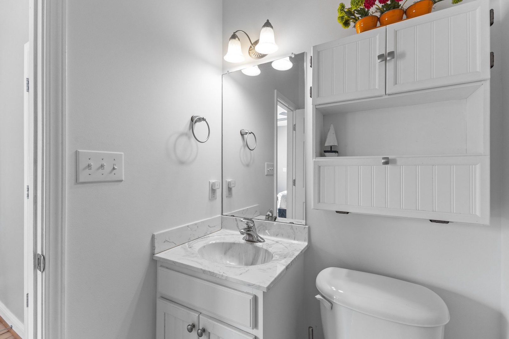 Step into your bright, well-appointed bathroom with marble countertops and ample storage for all your essentials.