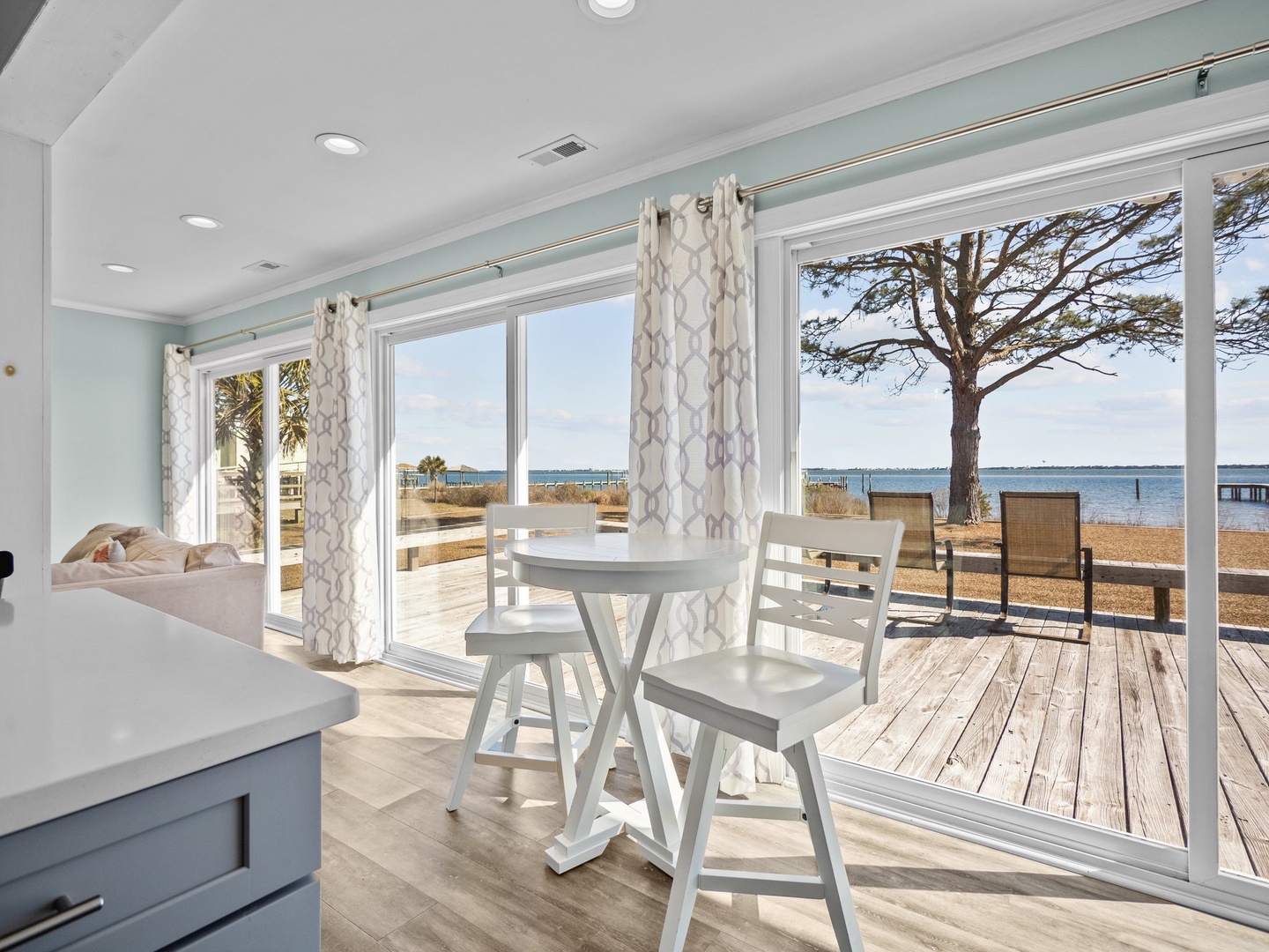 Your bright dining nook opens to waterfront views, where morning coffee feels extra special with the bay stretching beyond your private deck.