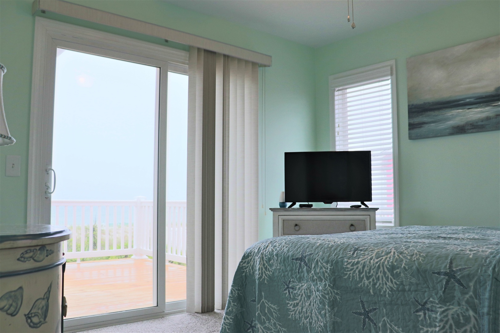 Wake up to serene sea views in this peaceful bedroom, where ocean breezes flow through sliding doors to your private balcony sanctuary.