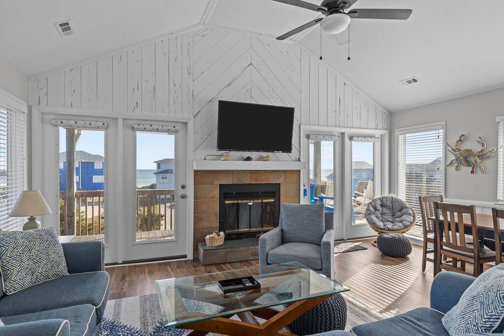 Unwind in your bright, airy living space with cozy seating around the fireplace and views of the coastal neighborhood.