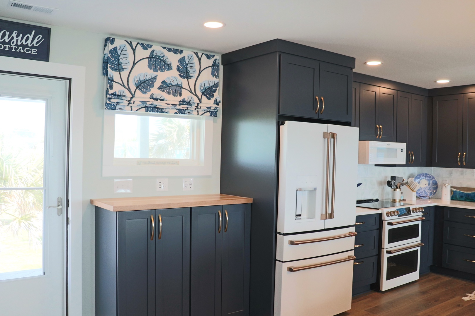 Your fully equipped kitchen features modern appliances and elegant blue cabinetry, perfect for preparing meals during your stay.