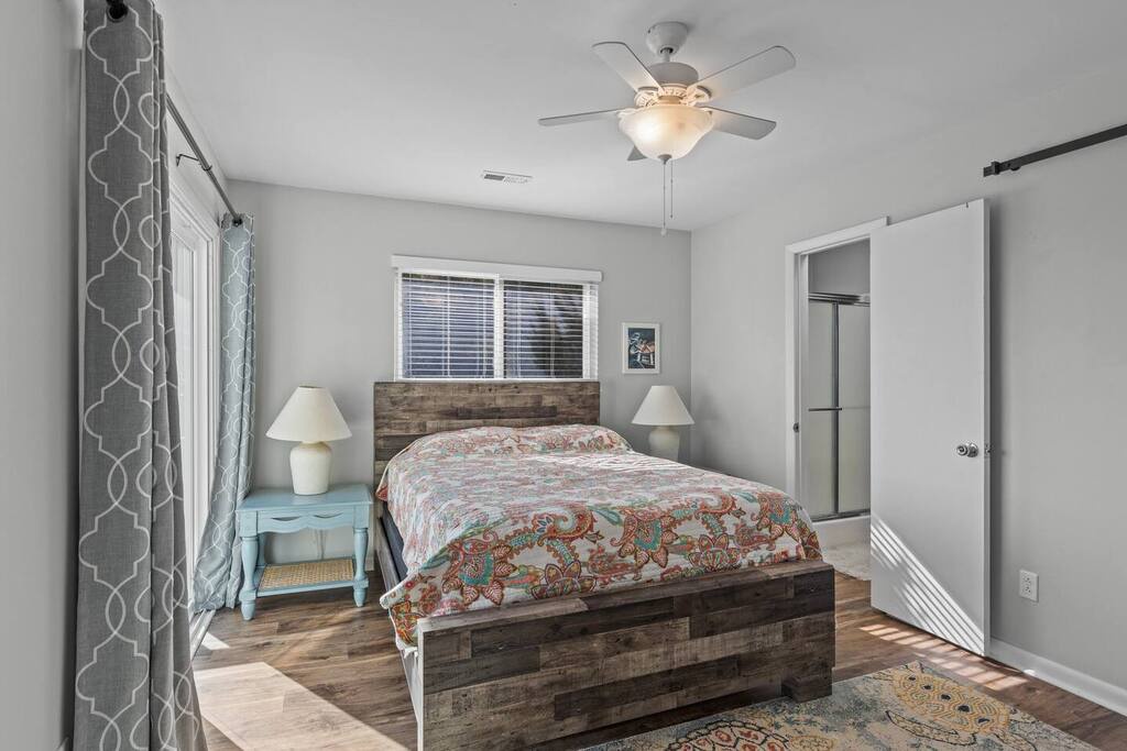 Slip into your cozy bedroom featuring rustic wood accents, soft lighting, and peaceful gray tones for ultimate relaxation.