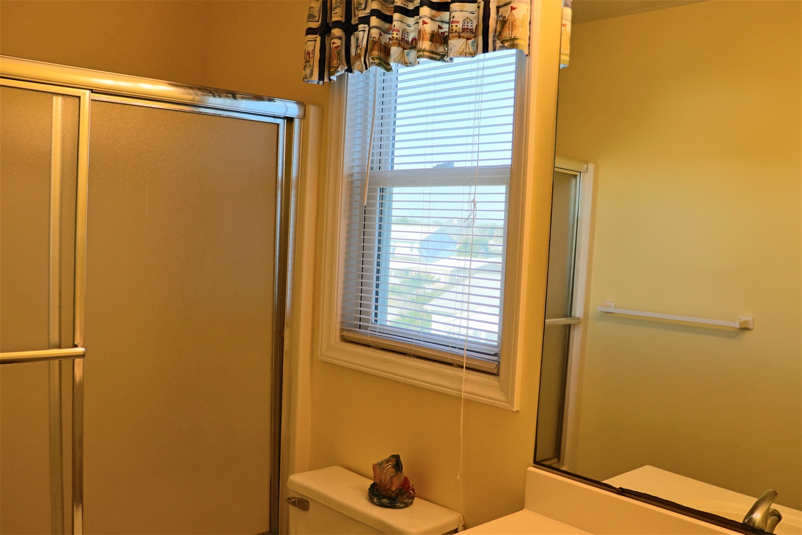 Freshen up in your private bathroom featuring a spacious shower, natural light, and thoughtful touches that make your morning routine feel special.