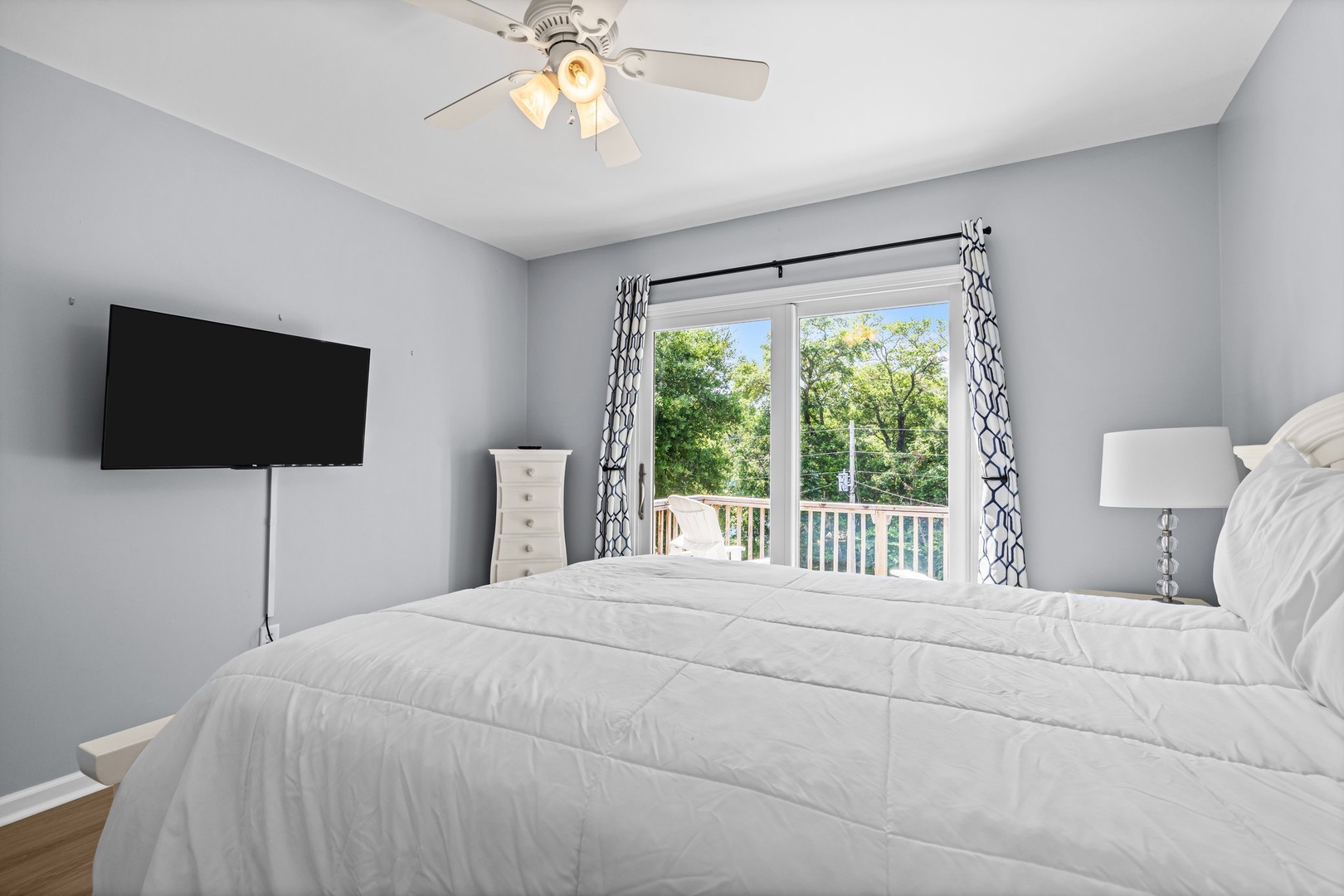 Rest peacefully in your serene bedroom with treetop views and gentle breezes from your private balcony.