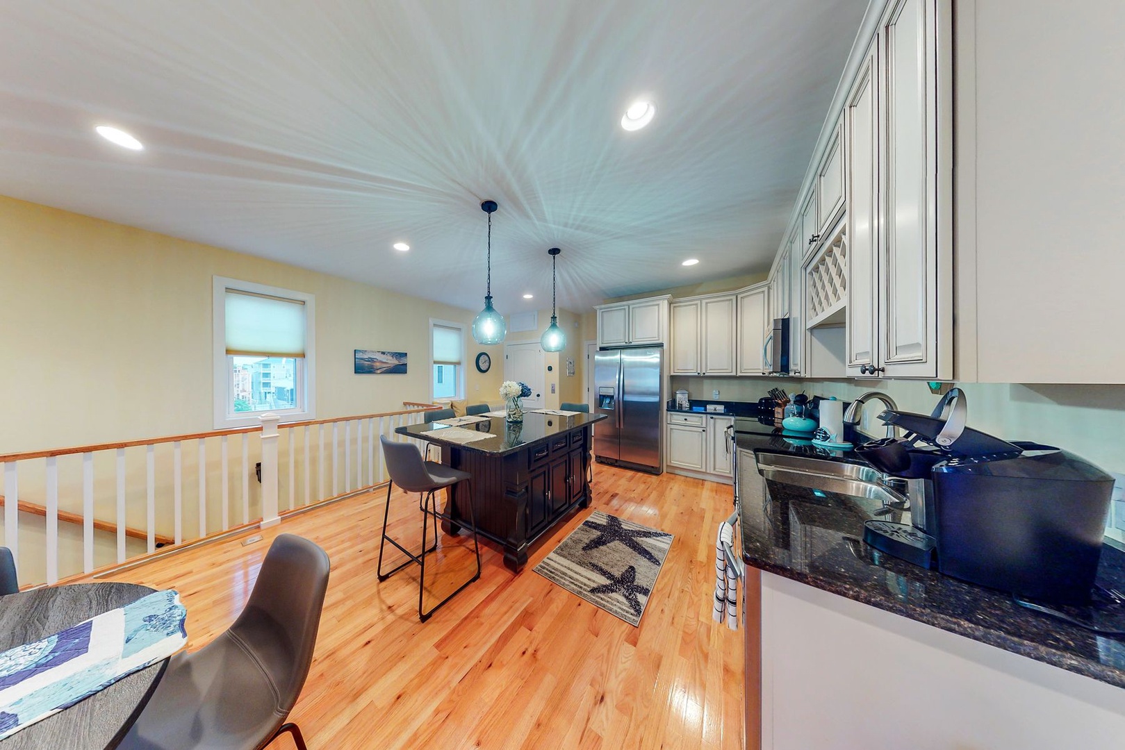 Your spacious kitchen features granite counters, stainless appliances, and a welcoming island perfect for morning coffee or evening meal prep.