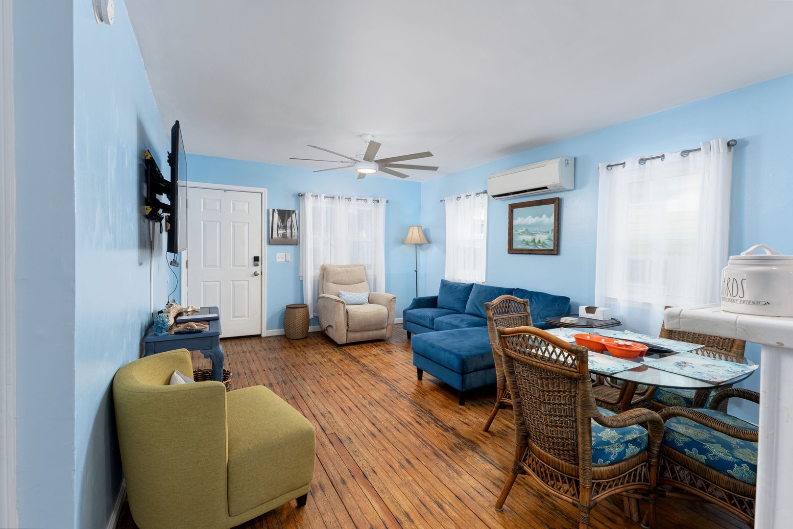 Unwind in your bright, welcoming living space with coastal charm, comfortable seating, and natural light flowing through large windows—your perfect retreat after a day exploring.