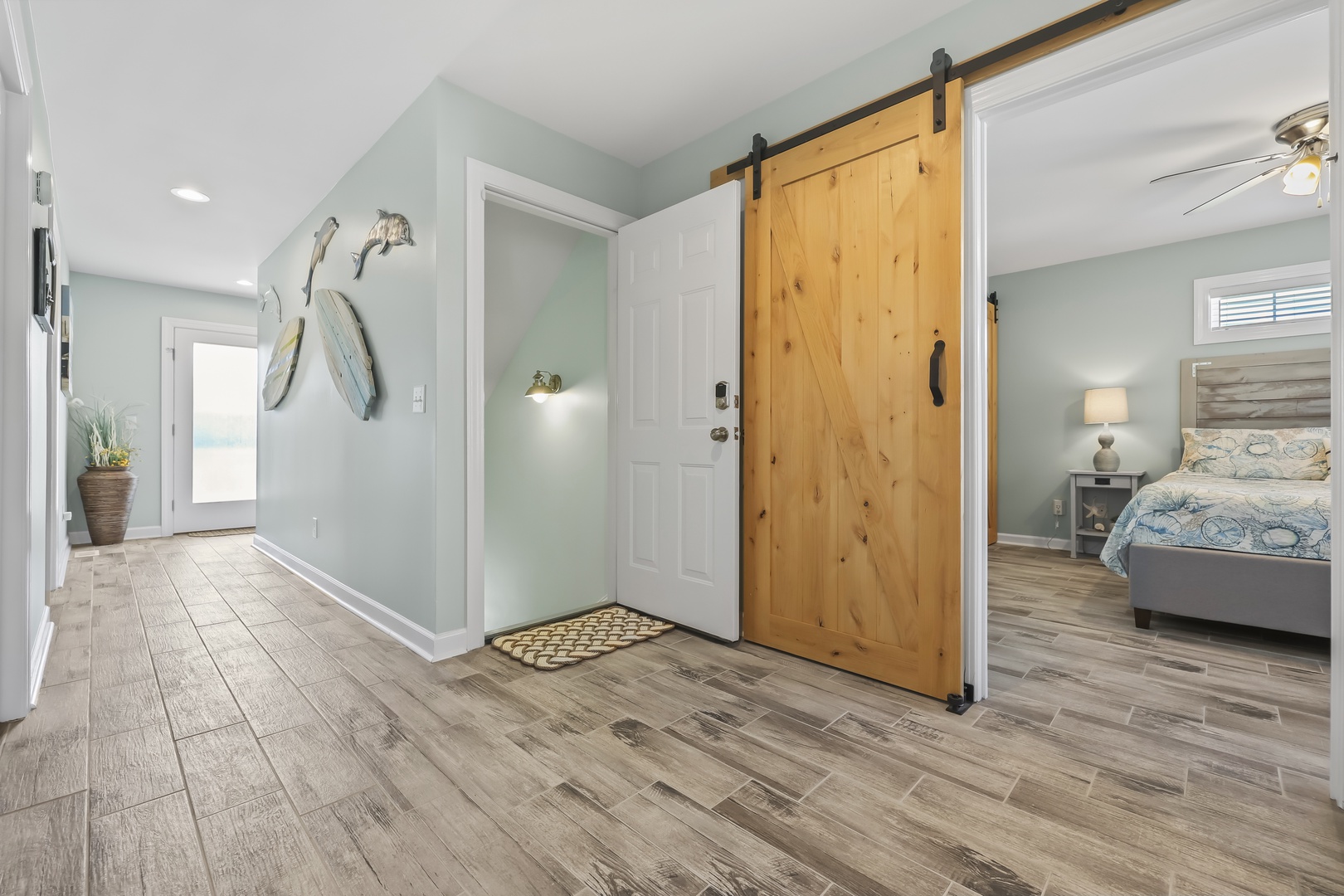 Soft coastal hues and a sliding barn door welcome you into your private retreat. The spacious layout flows seamlessly from entryway to bedroom, blending rustic charm with modern comfort.