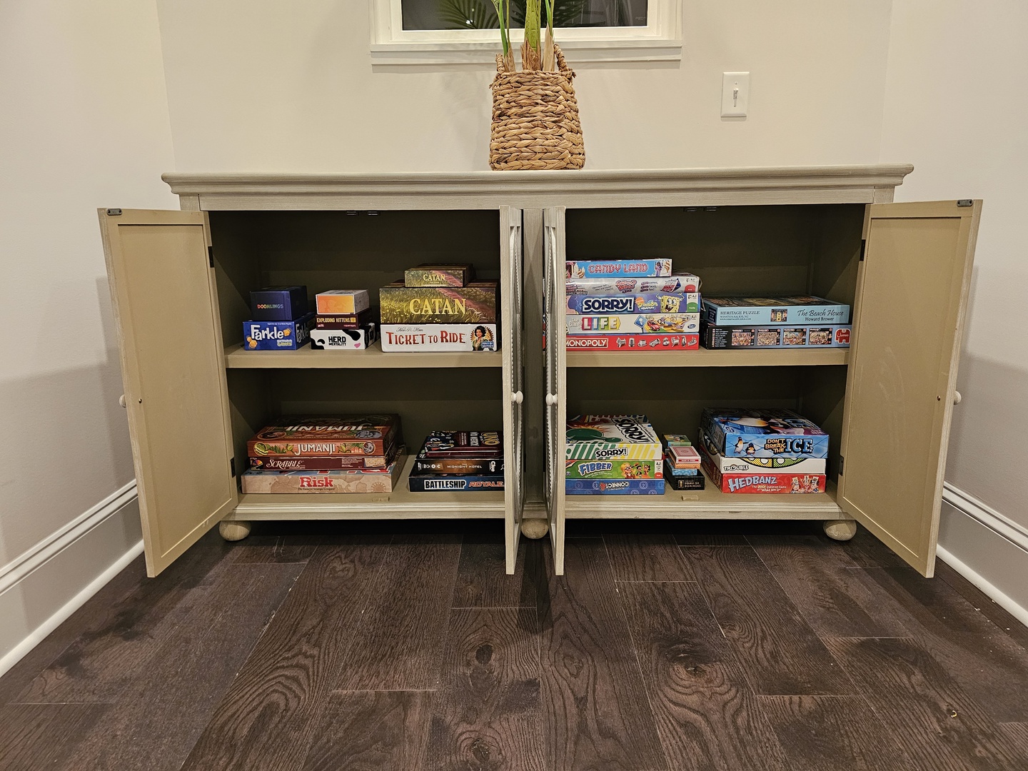 Your game cabinet awaits with classics like Catan, Monopoly, and Risk for cozy nights in with family and friends.