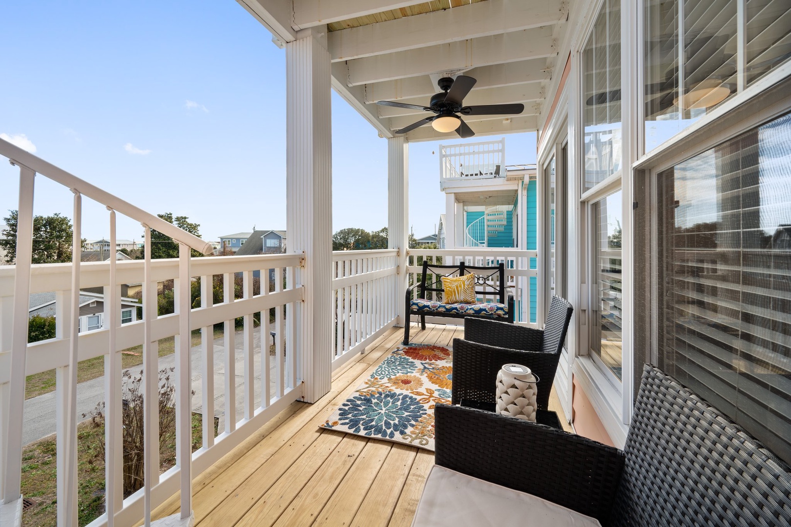 Your covered balcony offers a peaceful retreat with comfortable seating and gentle ceiling fan breezes—perfect for morning coffee or evening relaxation.