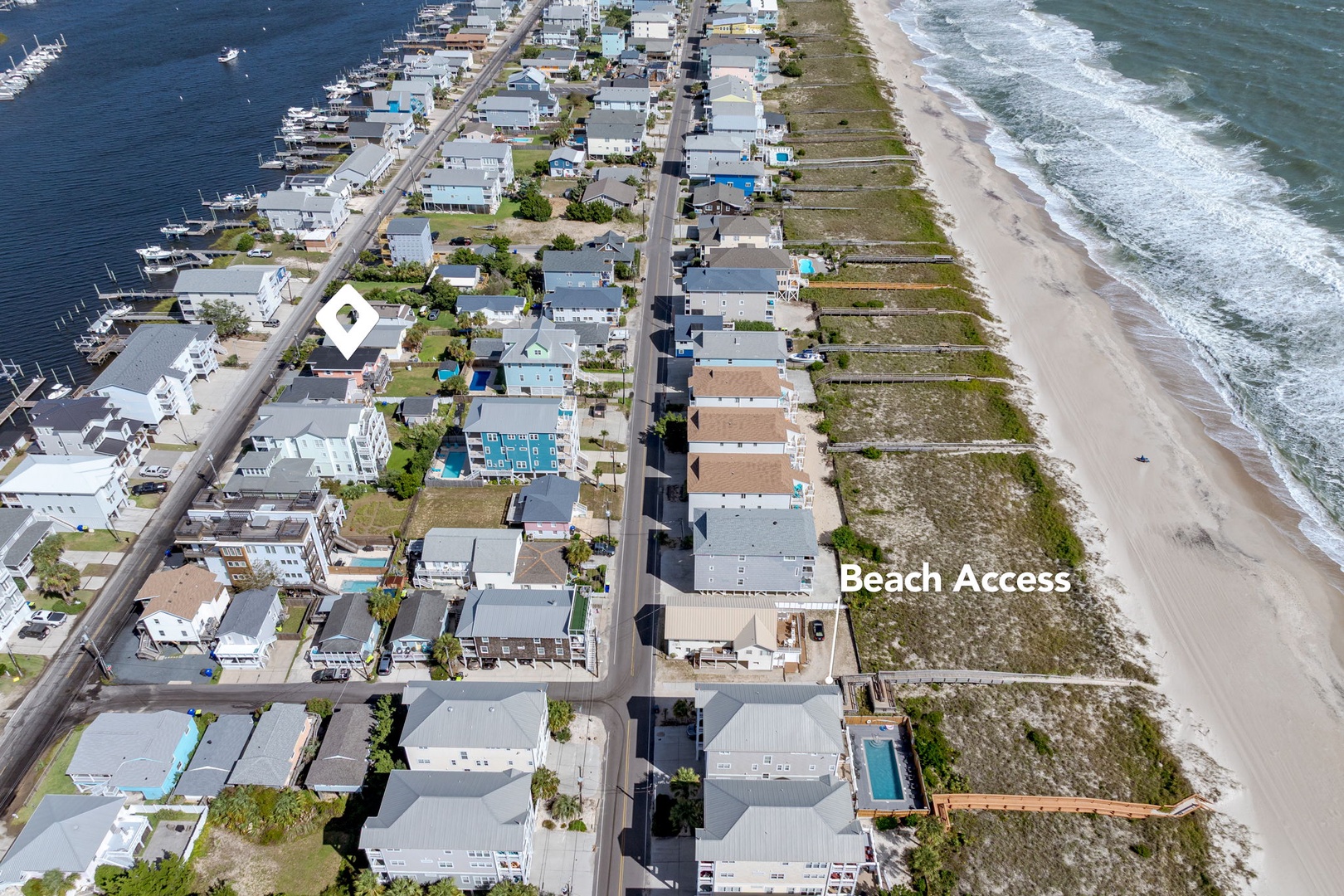 Aerial view showcasing the beachfront community with direct ocean access and nearby marina facilities.