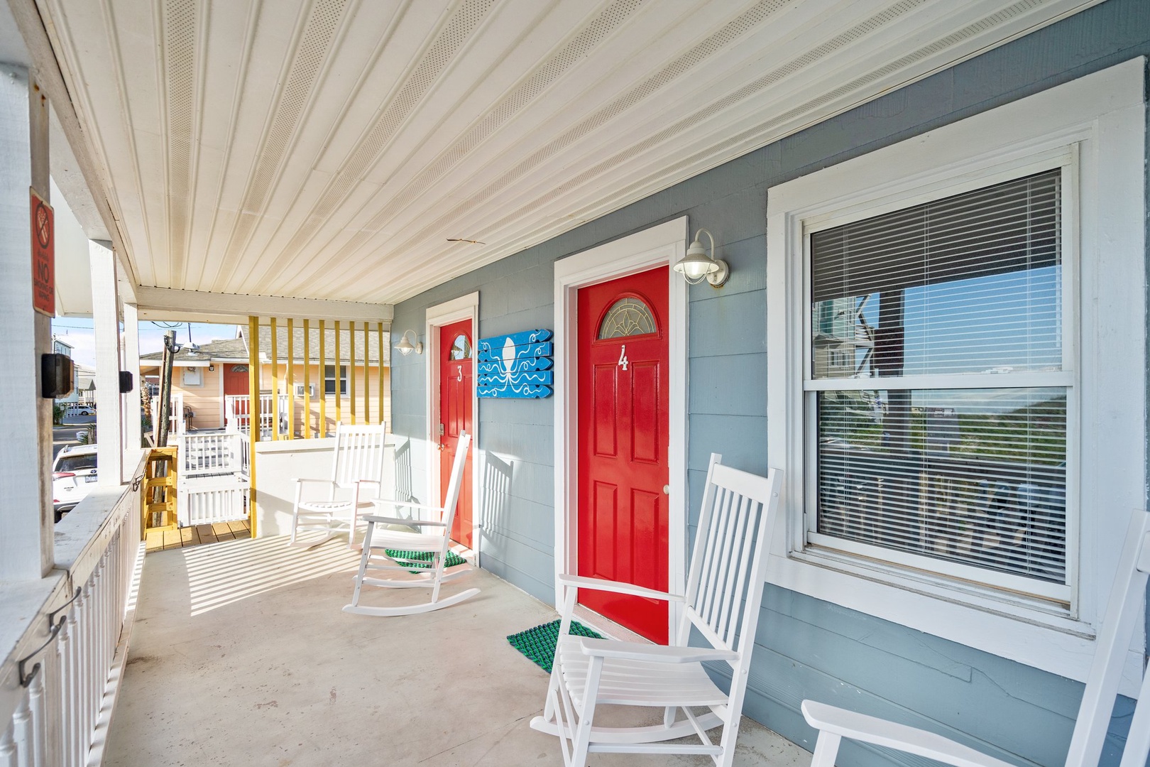 Relax on your charming covered porch with white rocking chairs and nautical touches, perfect for morning coffee or sunset conversations.