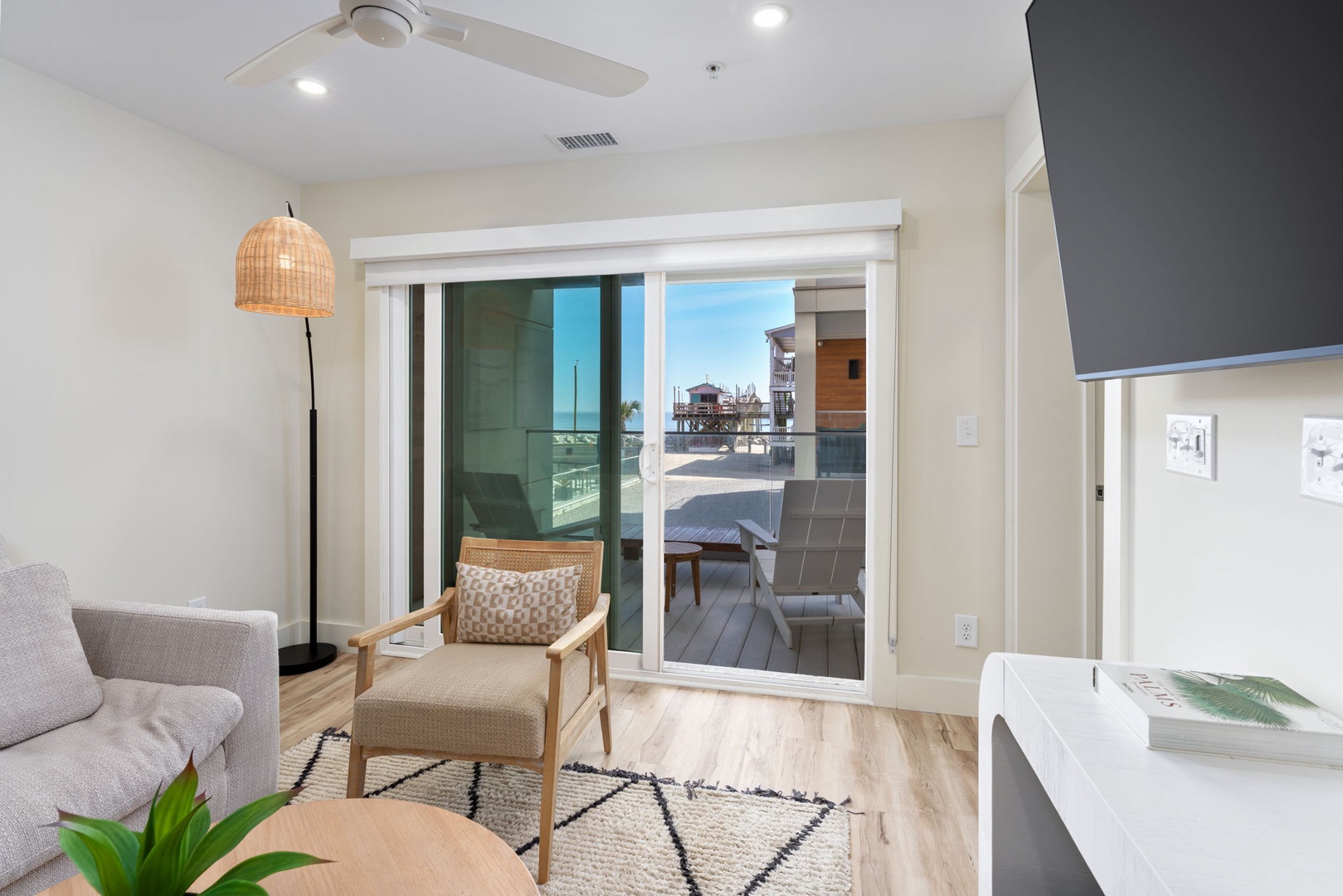 Relax in your bright living space with sliding doors that open to your private balcony, where coastal views await.