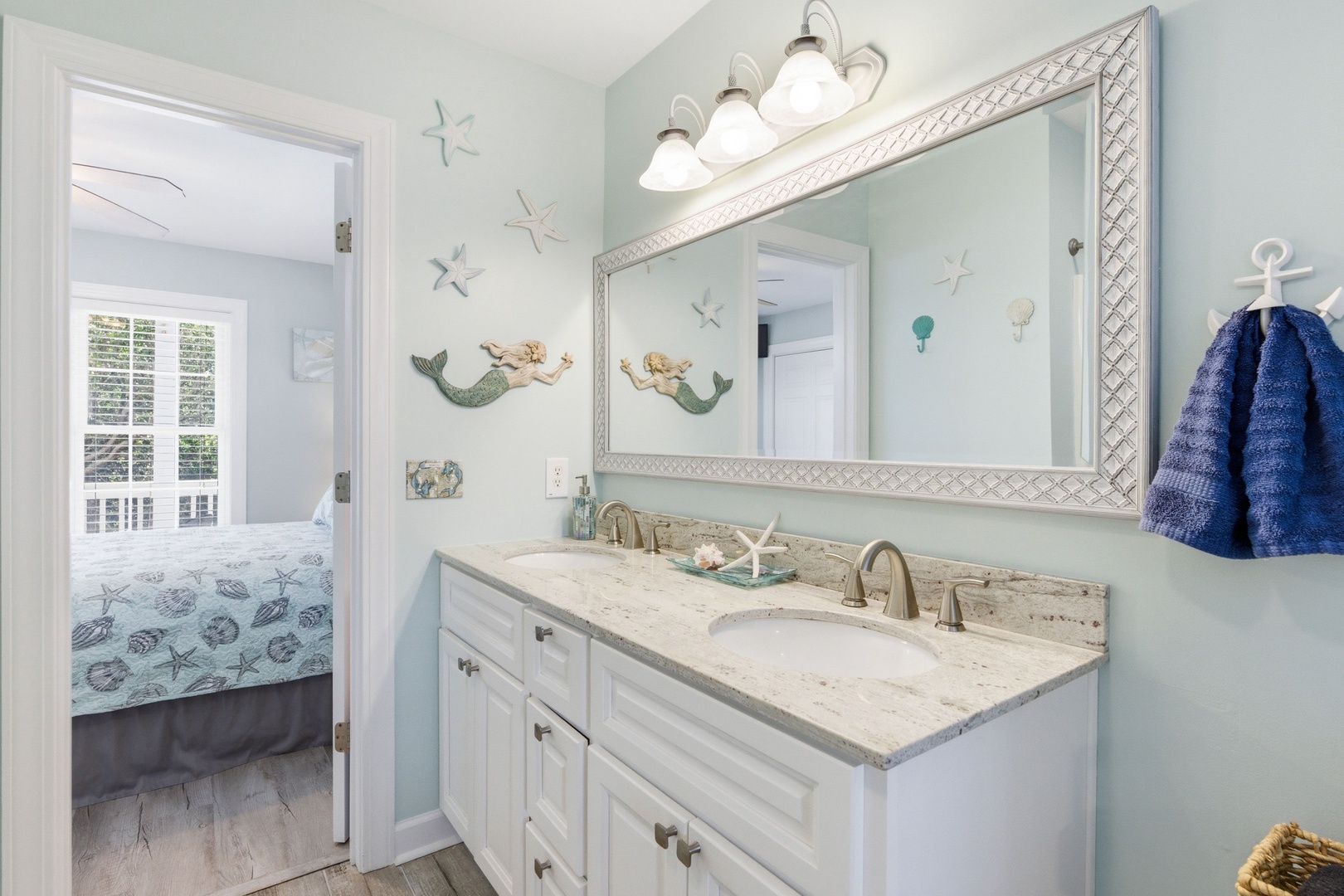 Freshen up in your coastal-inspired bathroom with double vanities, soft beachy tones, and charming mermaid accents—perfect for sharing the space or getting ready together.