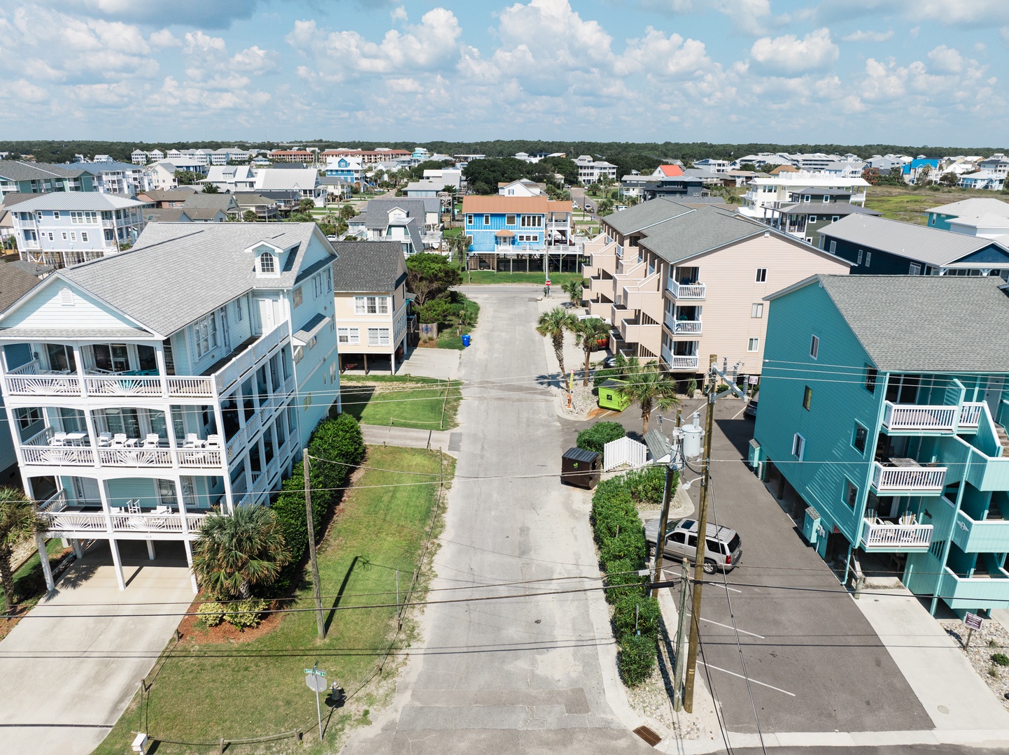 Aerial view of the coastal neighborhood featuring colorful beach houses and quiet residential streets.