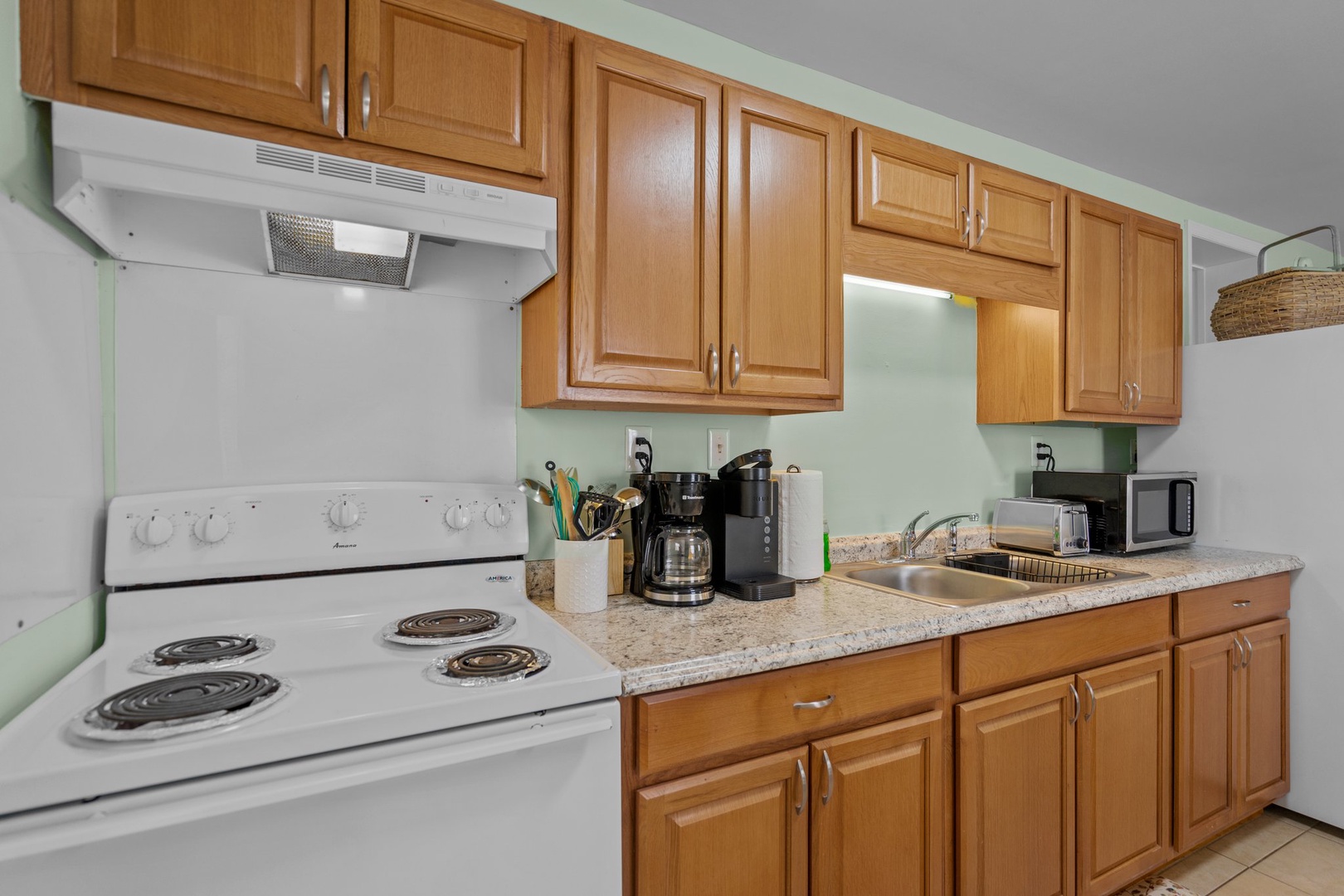 Your fully equipped kitchen features warm wood cabinets, granite countertops, and everything you need to prepare delicious meals during your stay.