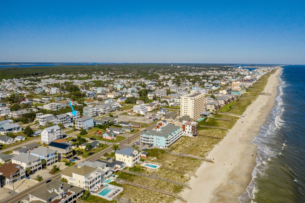 Expansive coastal community featuring pristine beachfront and diverse vacation rental properties along scenic shoreline.