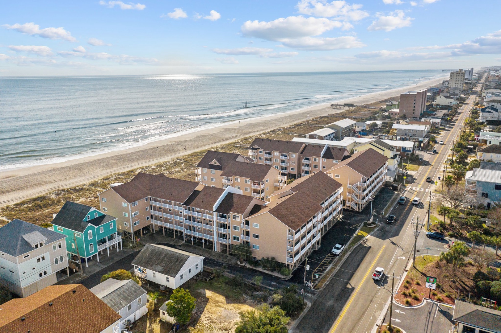 Beachfront resort complex offering stunning ocean access with expansive sandy shores and coastal community setting.
