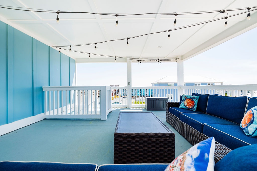 Unwind on your private covered terrace with plush seating, twinkling lights overhead, and ocean breezes surrounding you.