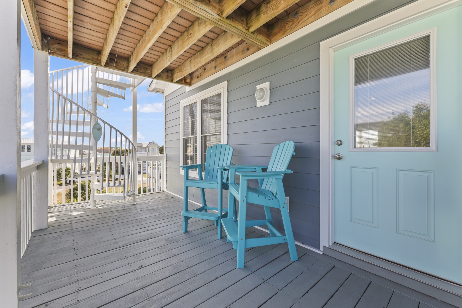 Settle into your private balcony chairs under the wooden beamed ceiling and soak up the coastal ambiance—your perfect retreat to unwind with morning coffee or evening conversation.