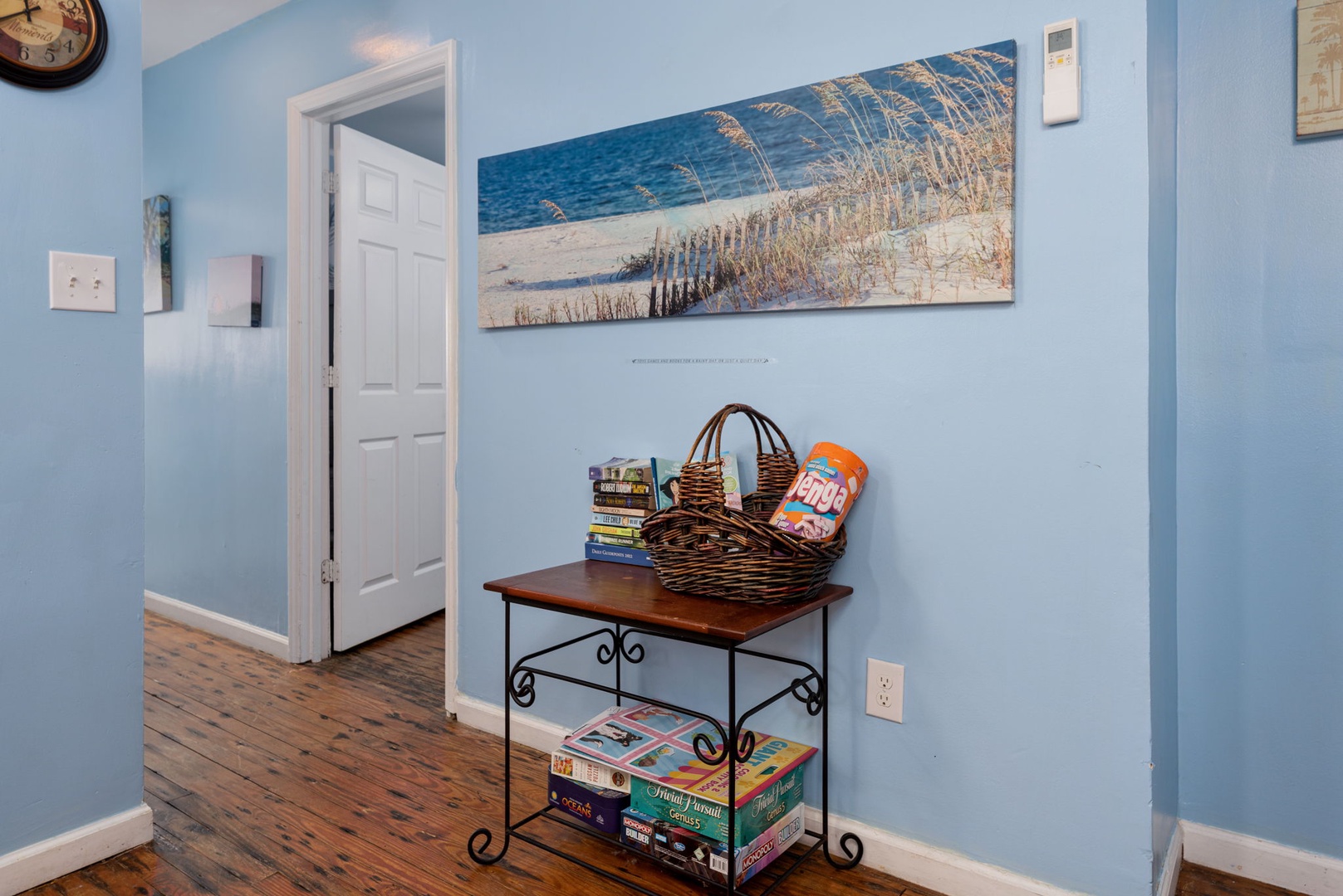 Step into your coastal retreat with calming blue walls and beach-inspired artwork welcoming you. Games and snacks await for cozy evenings together.