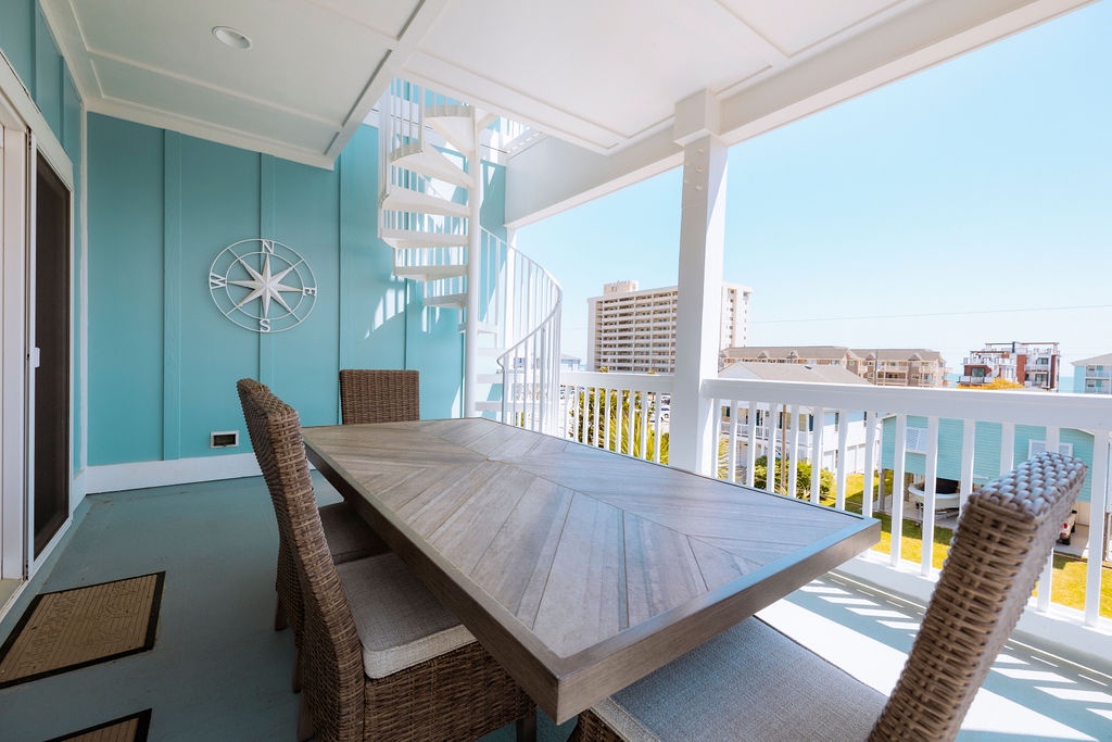 Your private covered balcony offers the perfect dining spot with wicker chairs and stunning city views for memorable meals.