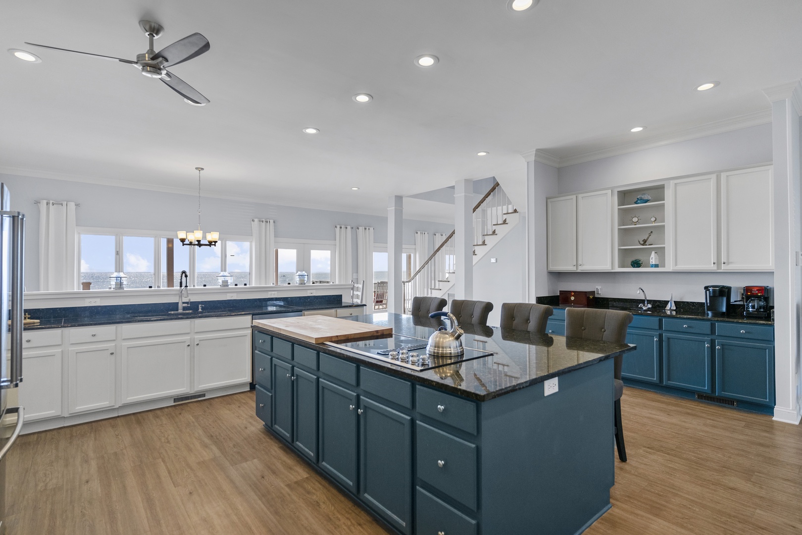 Cook memorable meals in your spacious modern kitchen with granite counters, full island seating, and stunning water views.