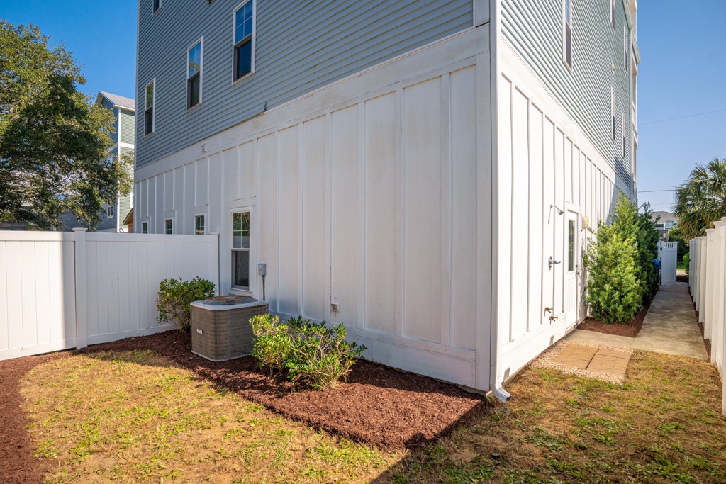 Modern property exterior with air conditioning unit and landscaped grounds in residential neighborhood setting.