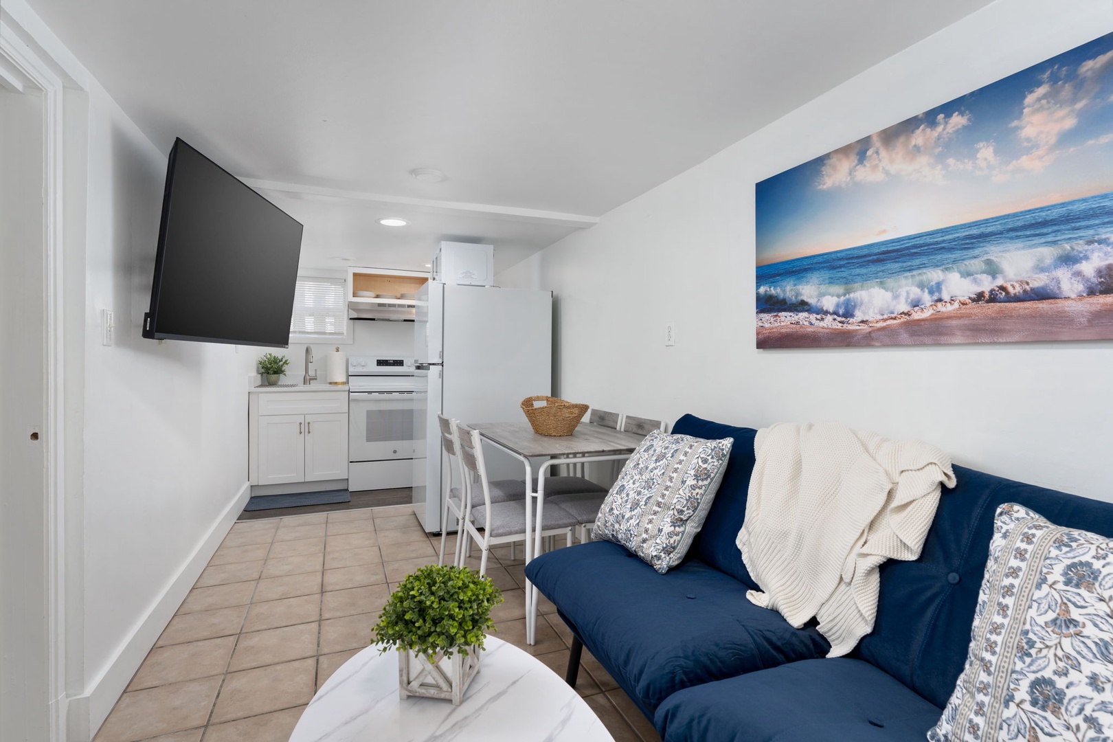 Unwind in your coastal-inspired living space where blue and white tones create a beachy vibe while you enjoy modern comforts.