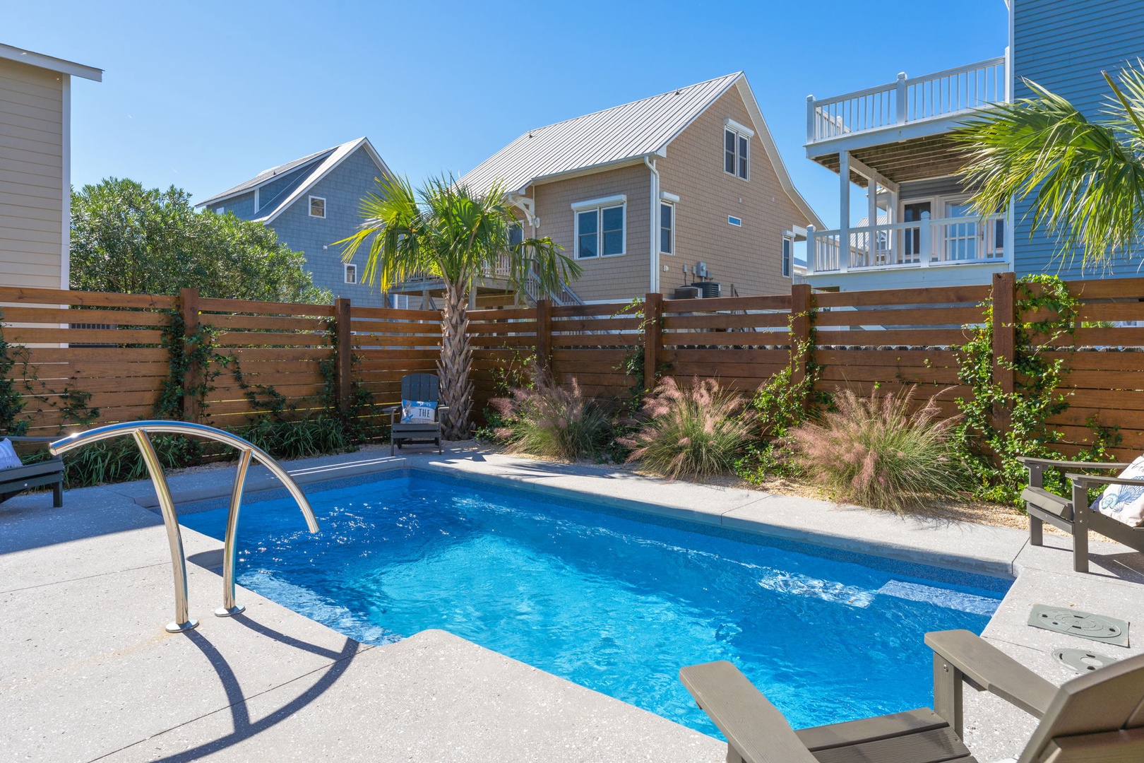 Dive into your private blue oasis surrounded by swaying palms and thoughtful landscaping—your perfect poolside retreat awaits.