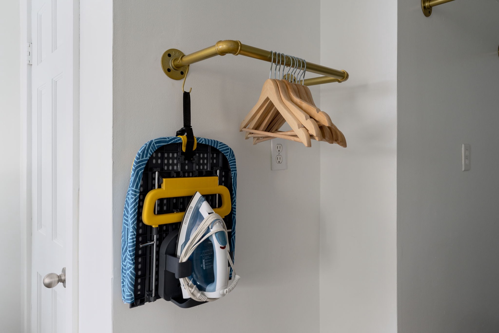Your thoughtfully designed closet features stylish brass hanging rods, quality hangers, and a convenient iron with board for keeping your wardrobe perfectly pressed.