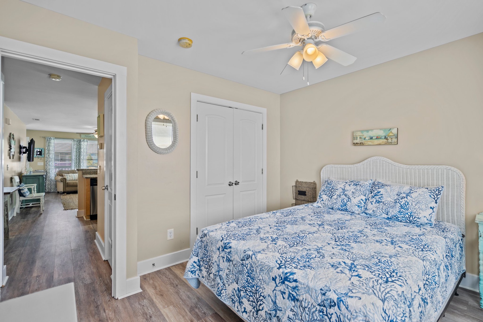 Drift into peaceful sleep in your coastal-inspired bedroom, where ocean-blue linens and gentle ceiling fan breezes create the perfect retreat.